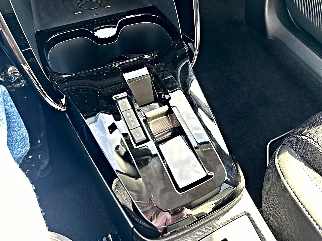 Vue rapprochée de la console centrale noire brillante avec levier de vitesses automatique dans un Citroën C3 Aircross.