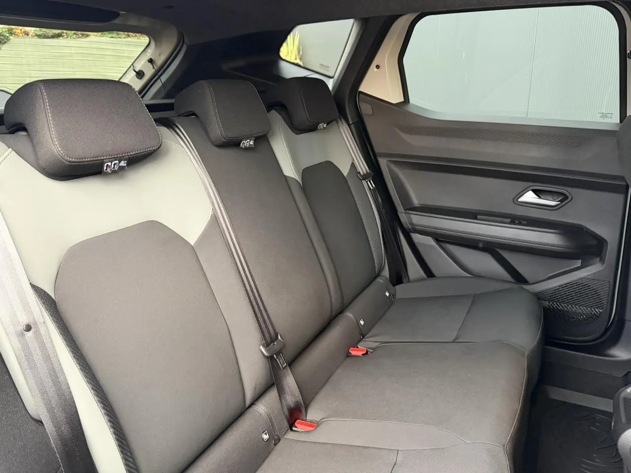 Vue latérale droite de la banquette arrière du Dacia Duster 2025, sellerie TEP MicroCloud gris foncé et beige.