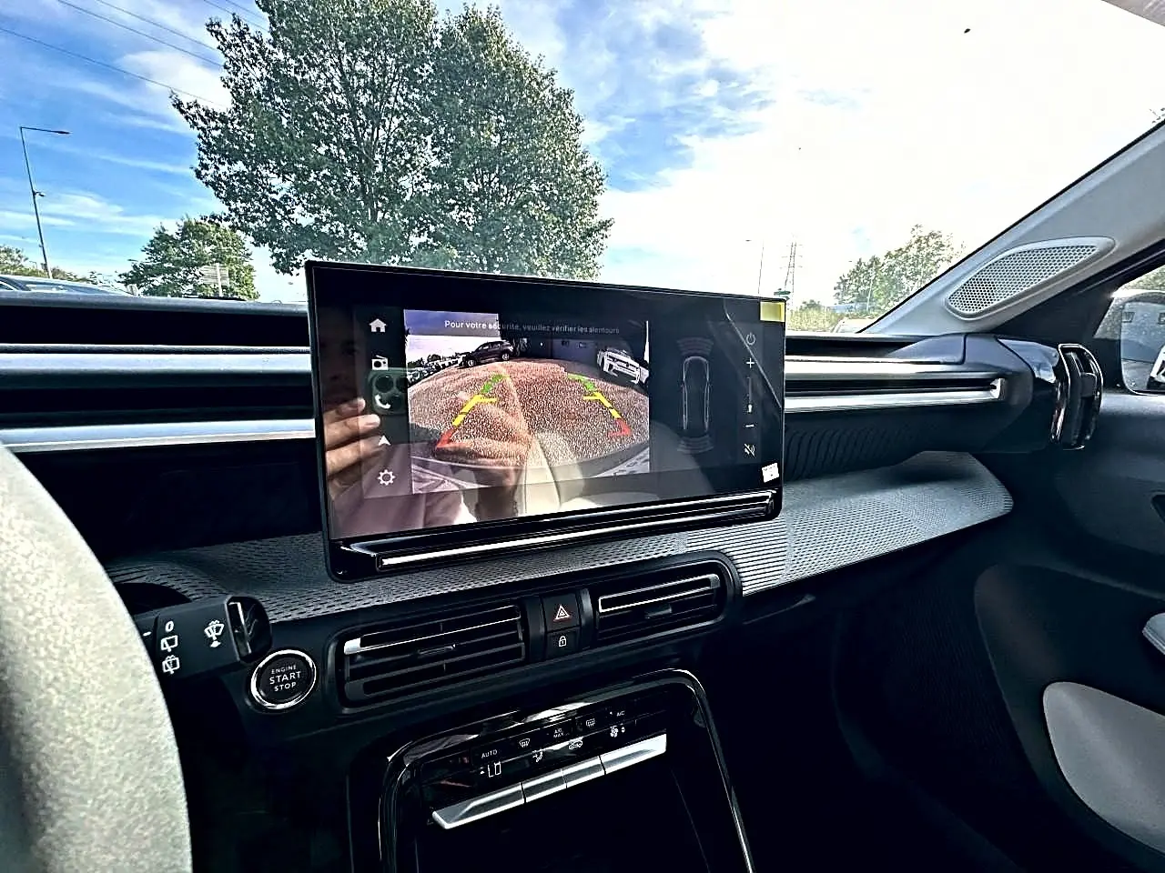 Vue intérieure côté conducteur du tableau de bord du Citroën C3 Aircross noir avec écran tactile affichant la caméra de recul.