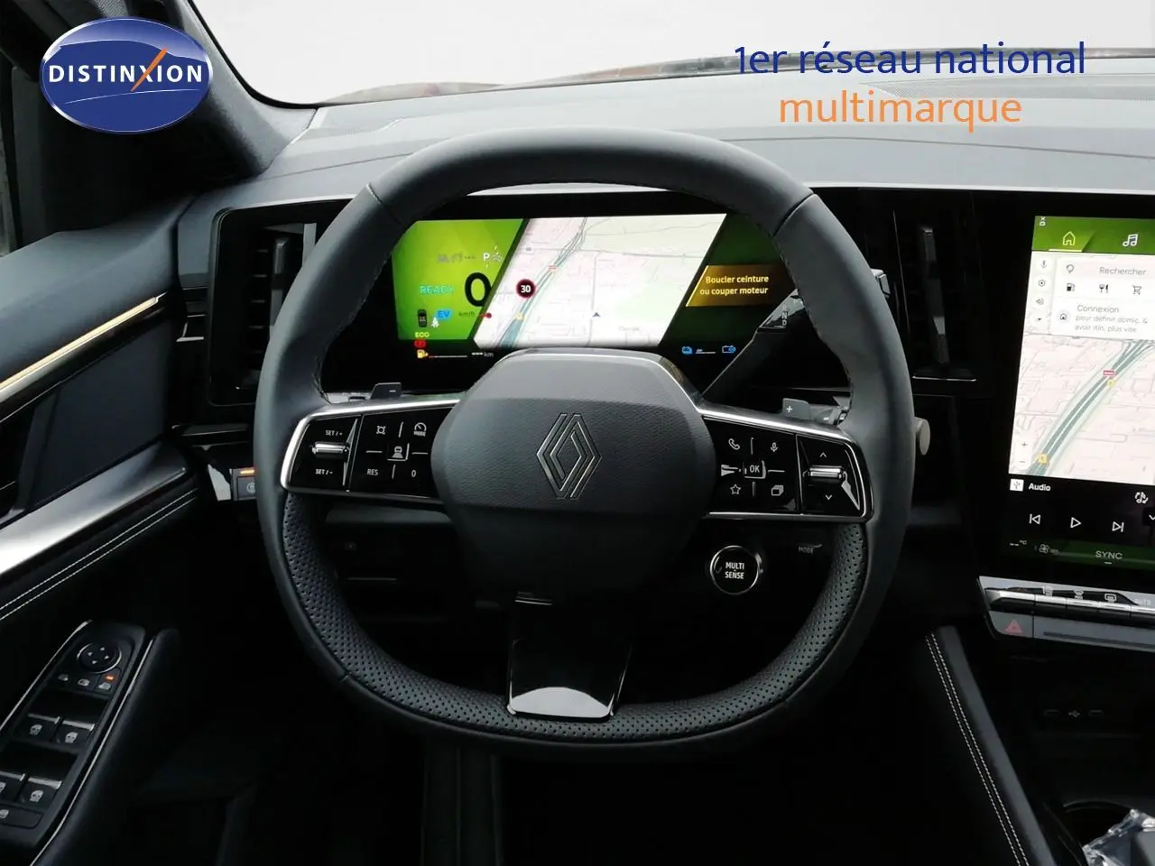 Vue intérieure centrée sur le volant noir perforé du Renault Austral E-Tech 2026 avec tableau de bord numérique et écran tactile.