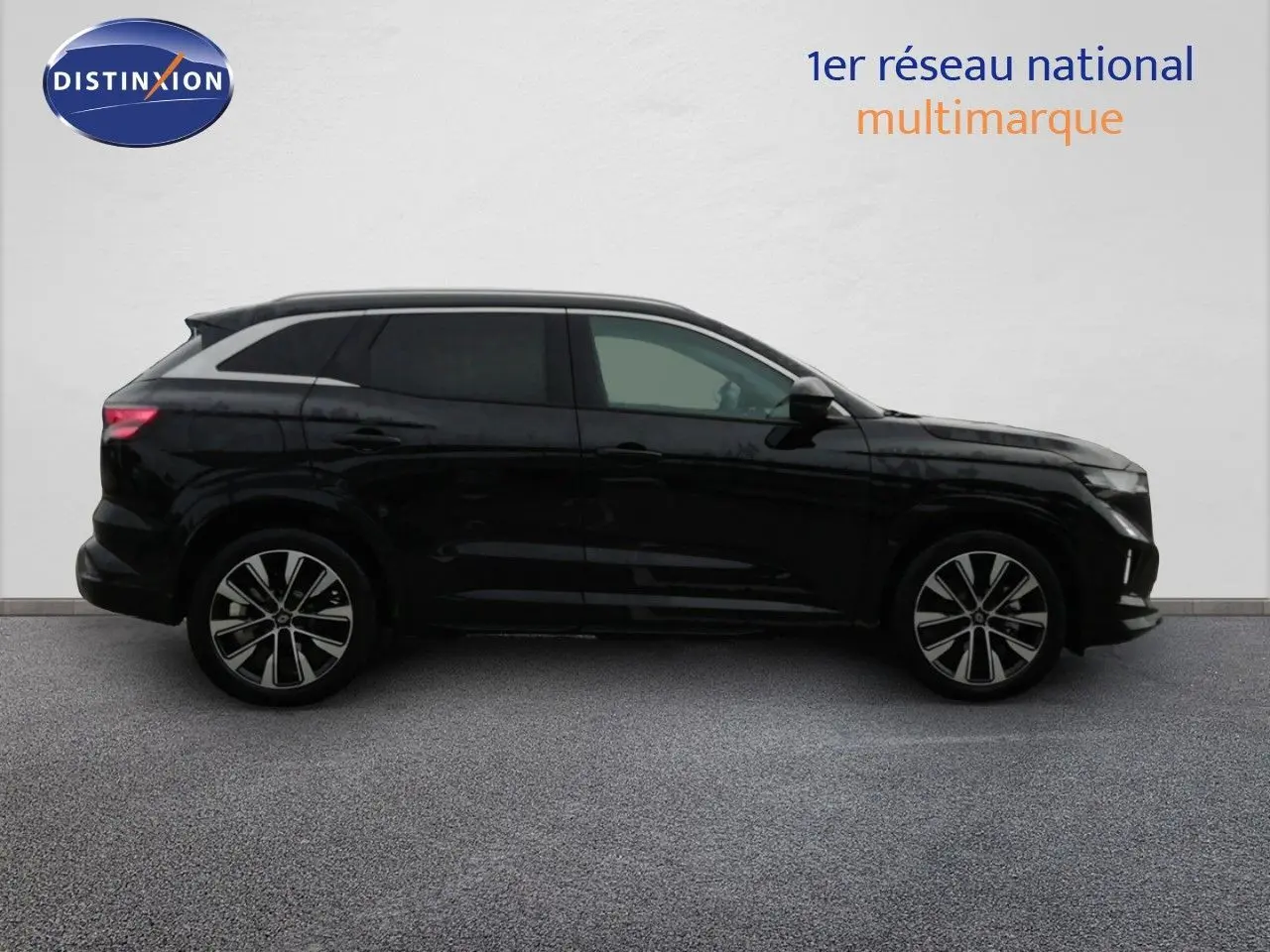 Profil droit d'un Renault Austral noir étoile métal 2026, SUV hybride avec jantes alliage bicolores.