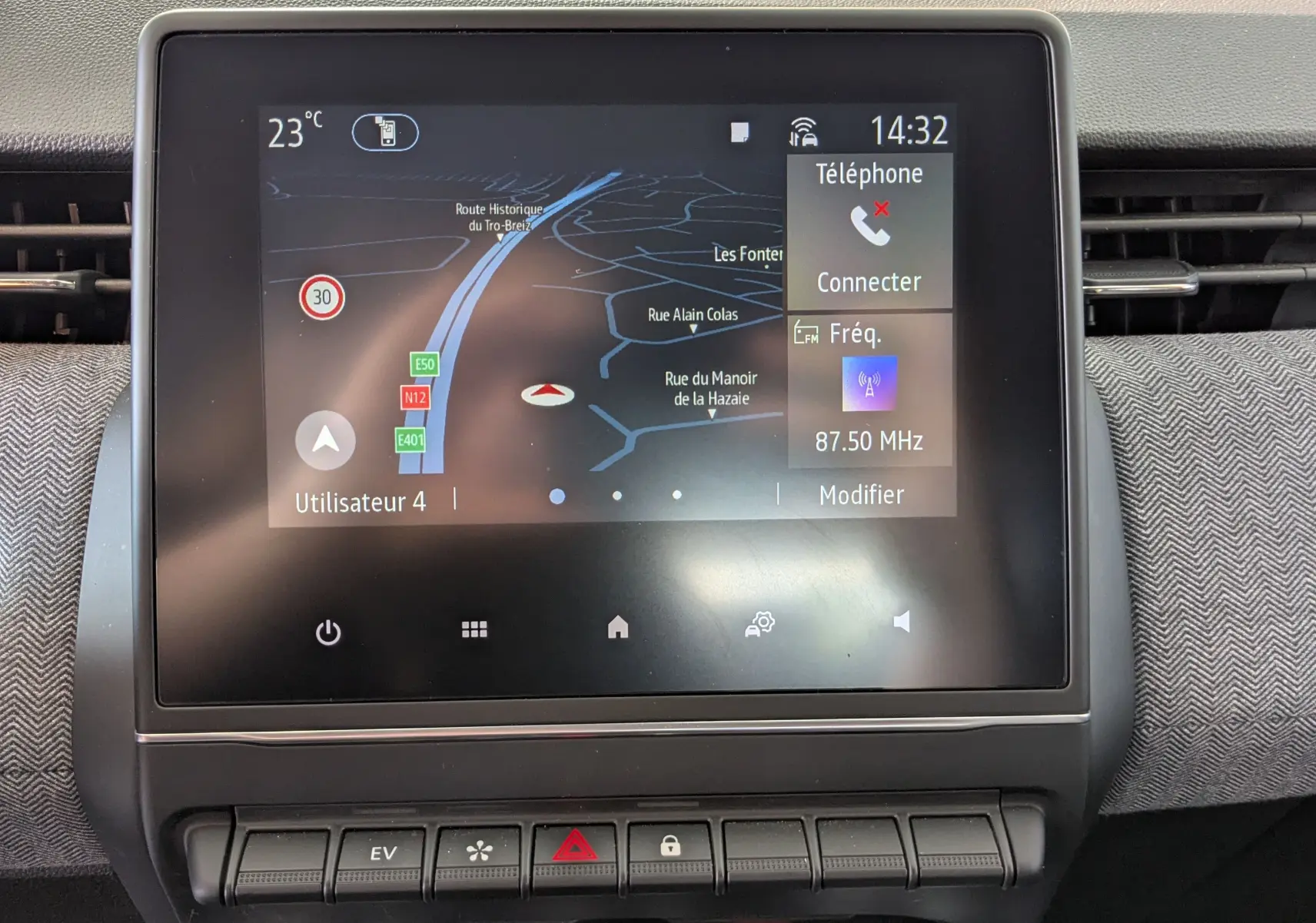 Écran tactile central de la Renault Clio gris schiste, affichant la navigation et les options multimédias, vue de face.
