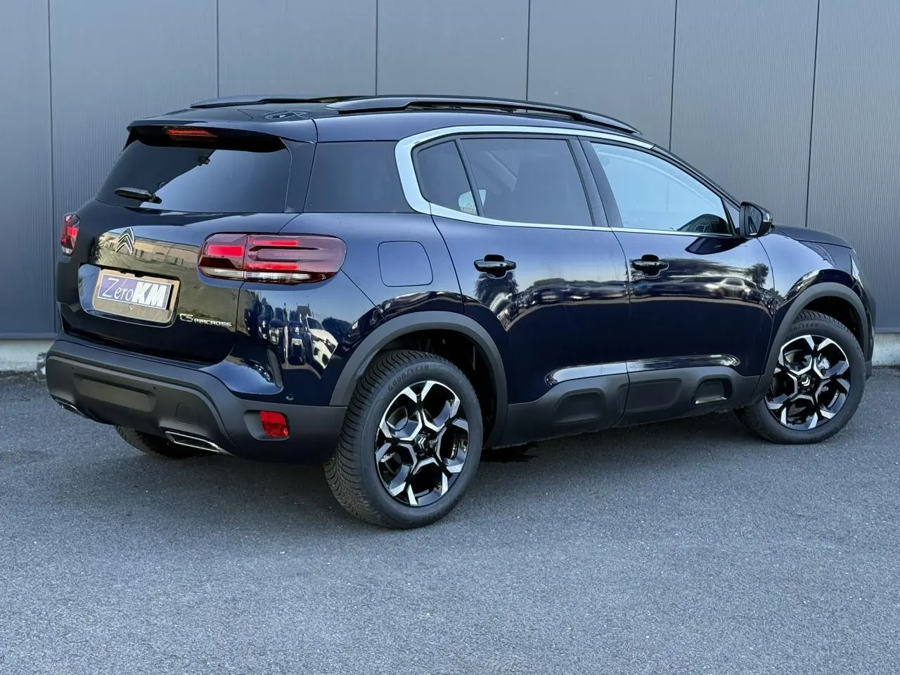 Vue 3/4 arrière droite d'un Citroën C5 Aircross Bleu Eclipse avec jantes alliage bi-ton et toit ouvrant panoramique.