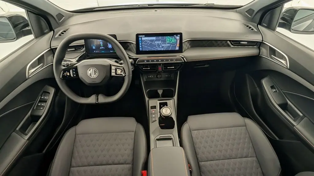 Vue intérieure avant du tableau de bord et volant noir de la MG3 1.5 L Hybrid+ Luxury avec écran tactile et sièges en similicuir.