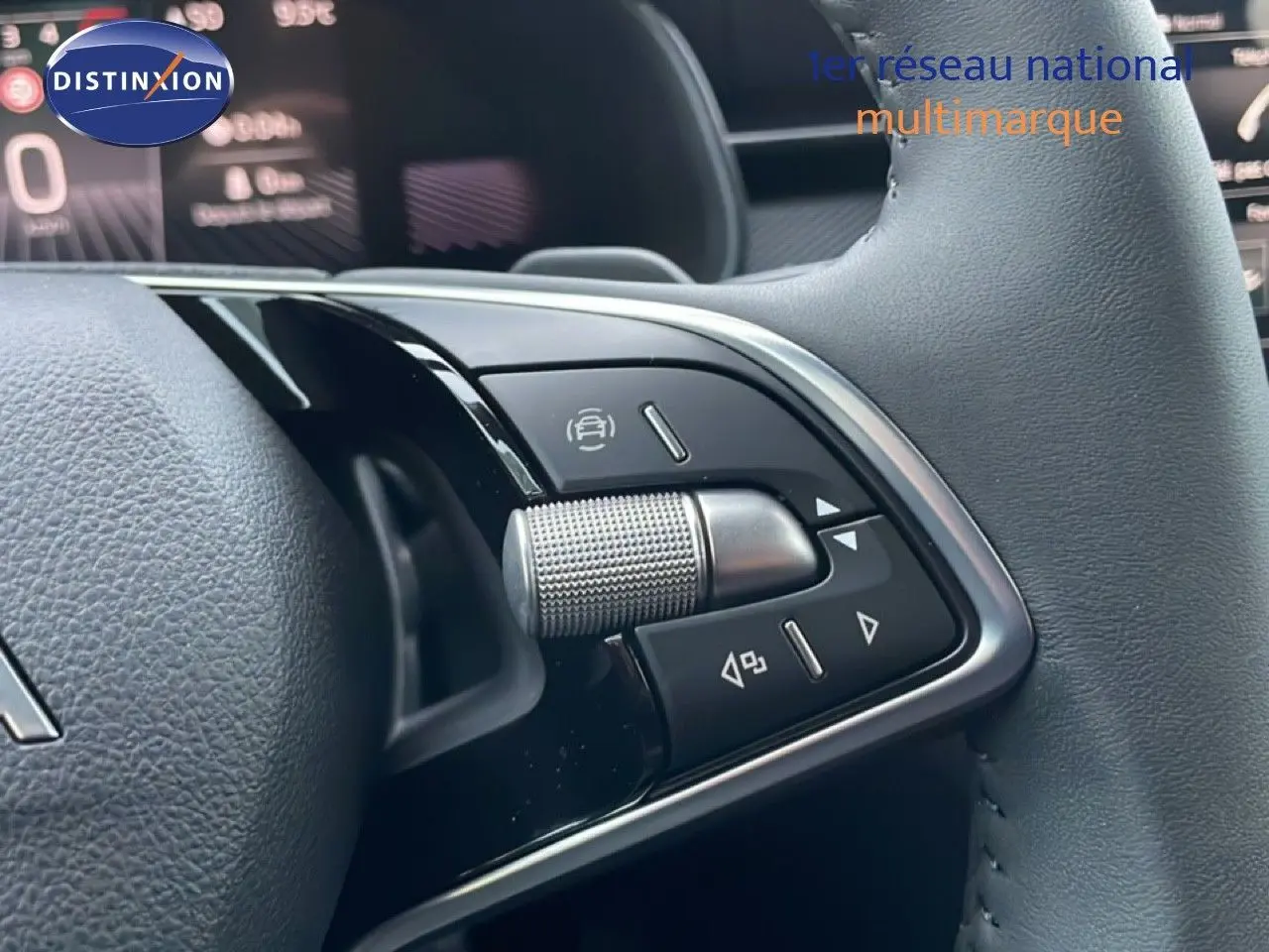 Gros plan sur les commandes multifonctions du volant cuir d'une Skoda Kamiq 2025, finition gris graphite métal.