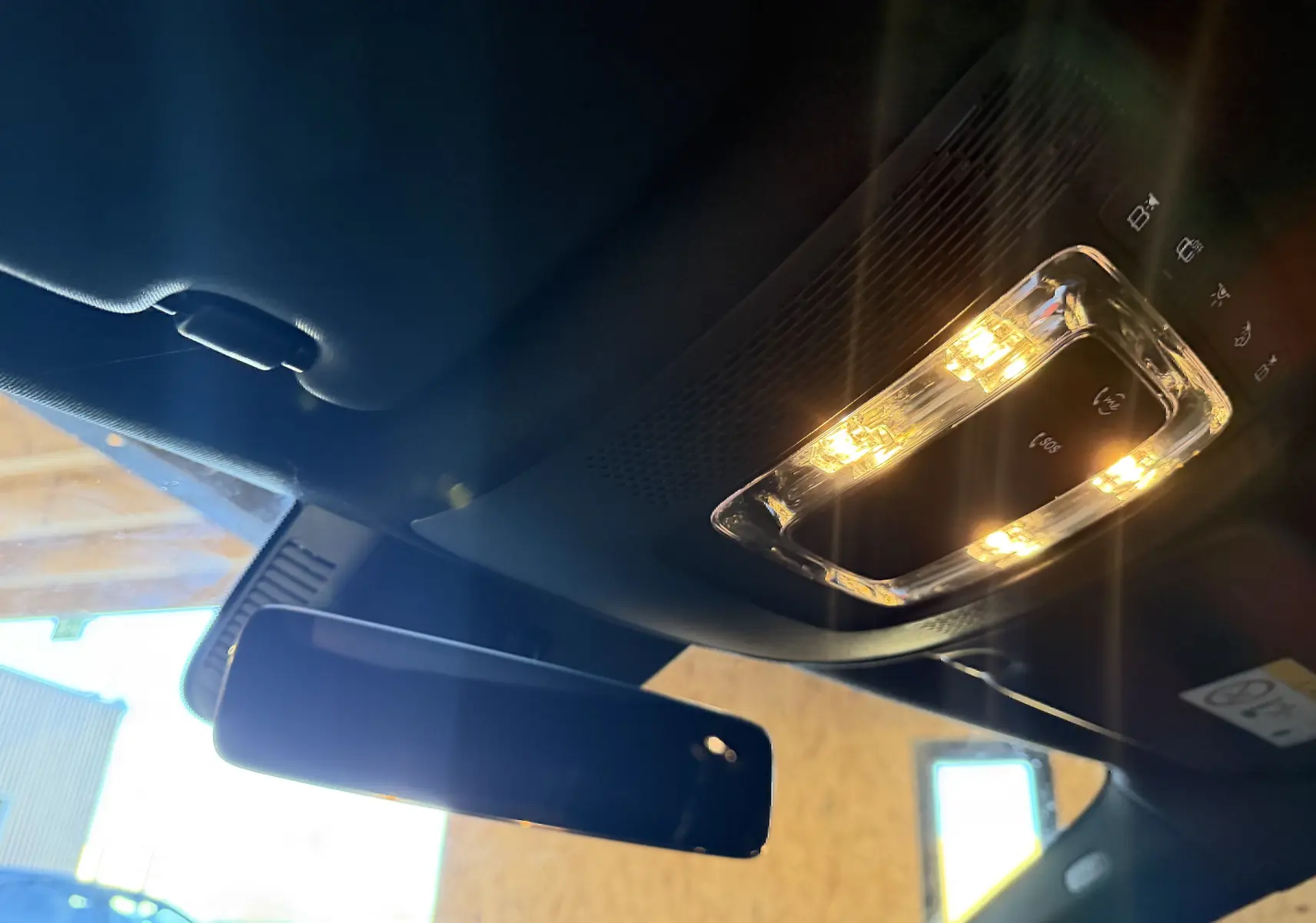 Vue intérieure du plafond avant noir de la Mercedes Classe A 2022 avec éclairage LED et rétroviseur central.