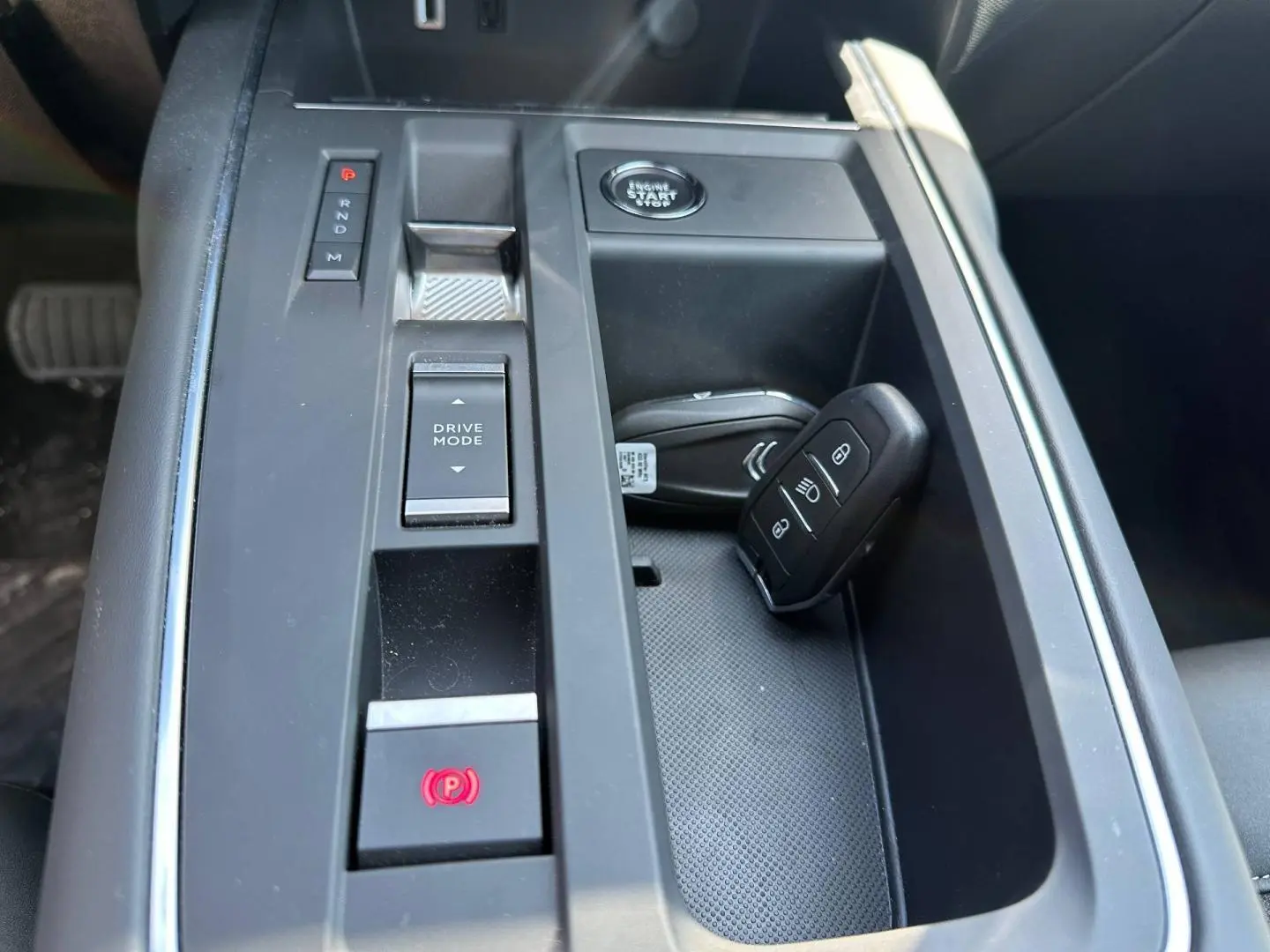 Vue rapprochée de la console centrale noire du Citroën C5 Aircross 2025 avec clé et boutons de boîte automatique.