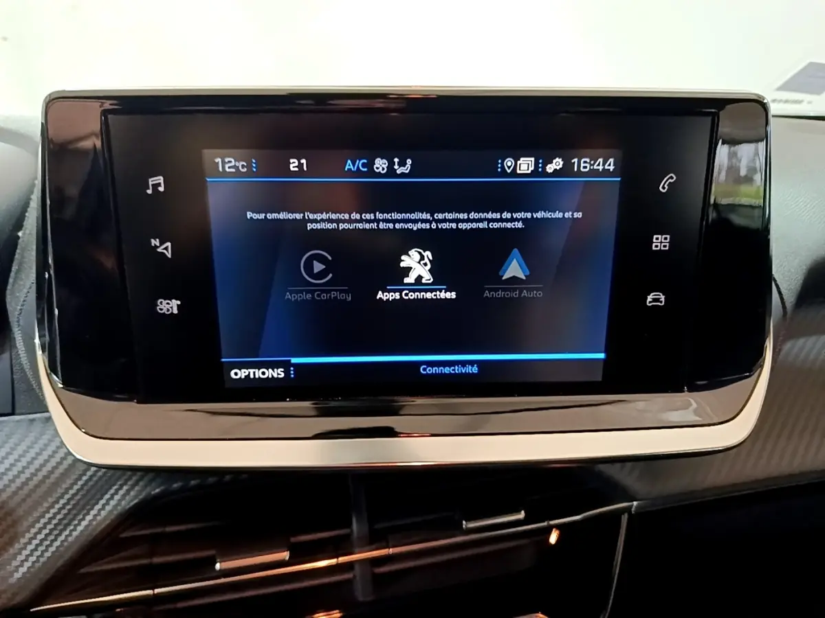 Écran tactile central du tableau de bord du Peugeot 2008 gris clair, affichant les options Apple CarPlay et Android Auto.
