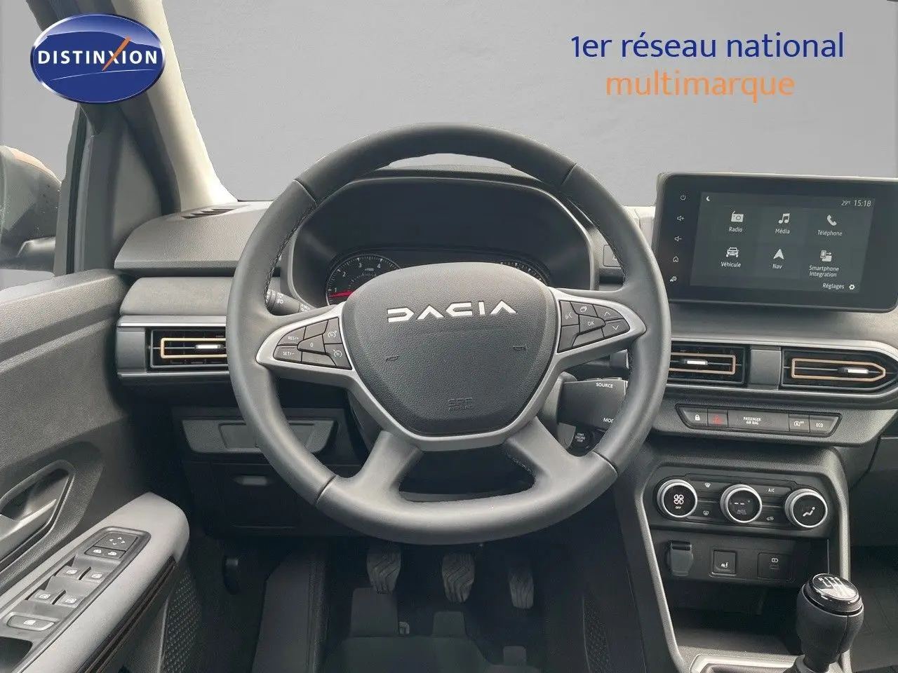 Vue frontale de l'intérieur du Dacia Sandero Stepway 2024, avec volant, tableau de bord et écran multimédia visible.