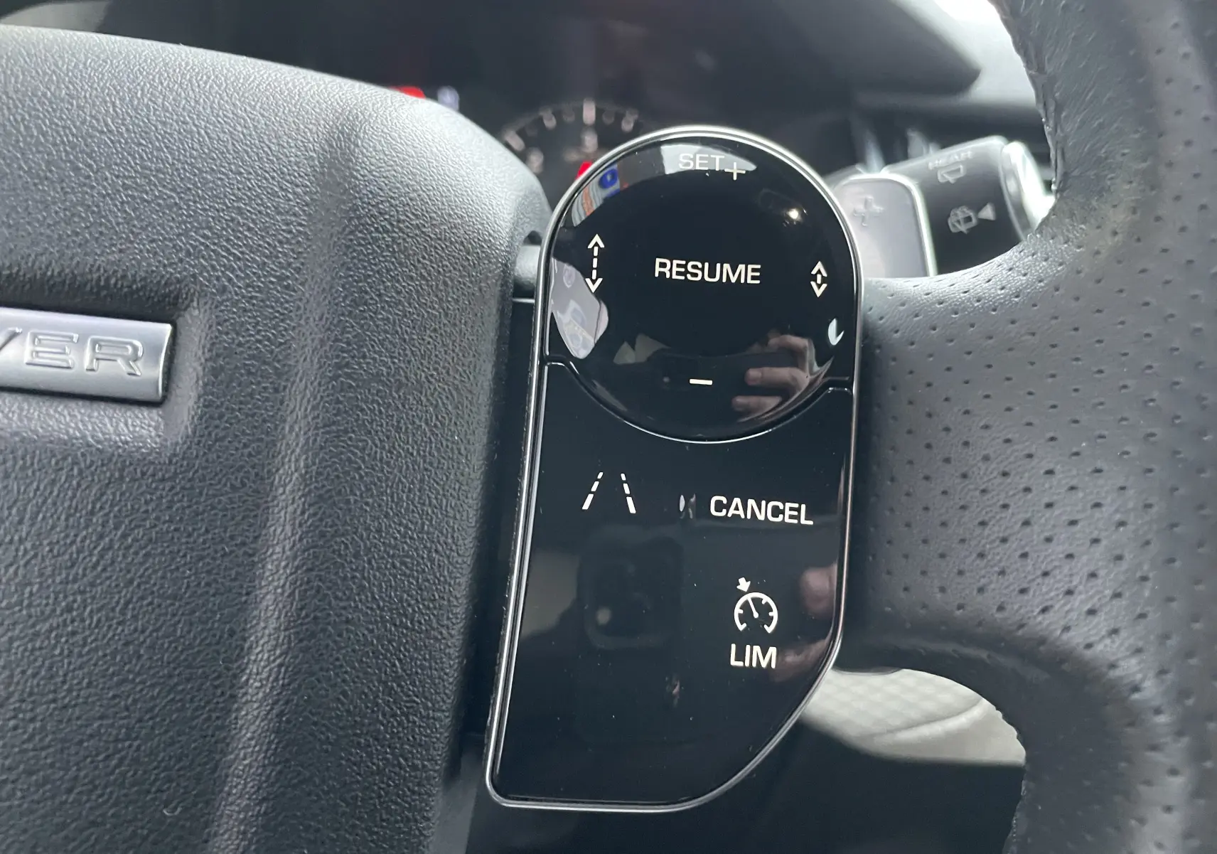 Gros plan sur les commandes au volant côté gauche du Range Rover Velar D300 2018, finition Silicon Silver.