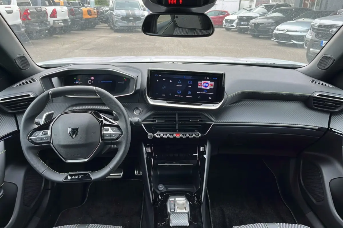 Vue intérieure du tableau de bord du Peugeot 2008 Hybrid 145 GT Vision 2025 avec volant compact et écran tactile central.
