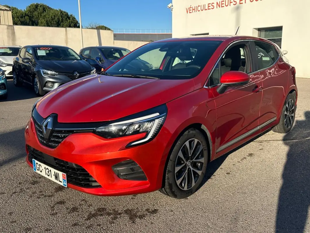 Renault Clio rouge foncé vue 3/4 avant droit, avec jantes alliage 17 pouces et rétroviseurs assortis.