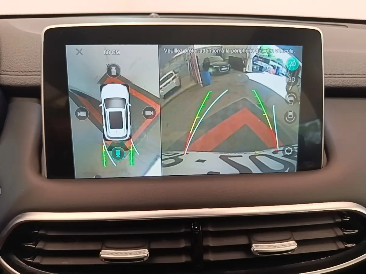 Écran tactile intérieur montrant la caméra 360° et l'aide au stationnement du MG Motor EHS blanc en vue arrière.