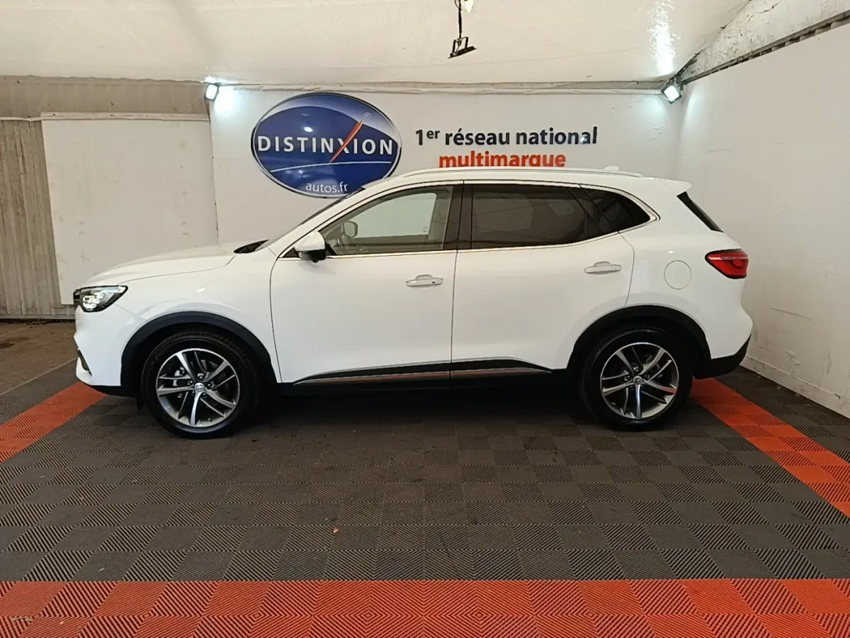 Vue de profil côté gauche du SUV blanc MG EHS 1.5T GDI PHEV Luxury 2023 dans un showroom intérieur.