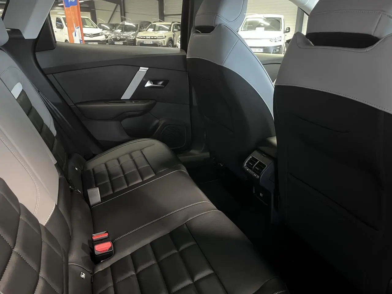 Vue intérieure arrière de la Citroën C4 2025 montrant les sièges Advanced Comfort en tissu noir et gris clair.