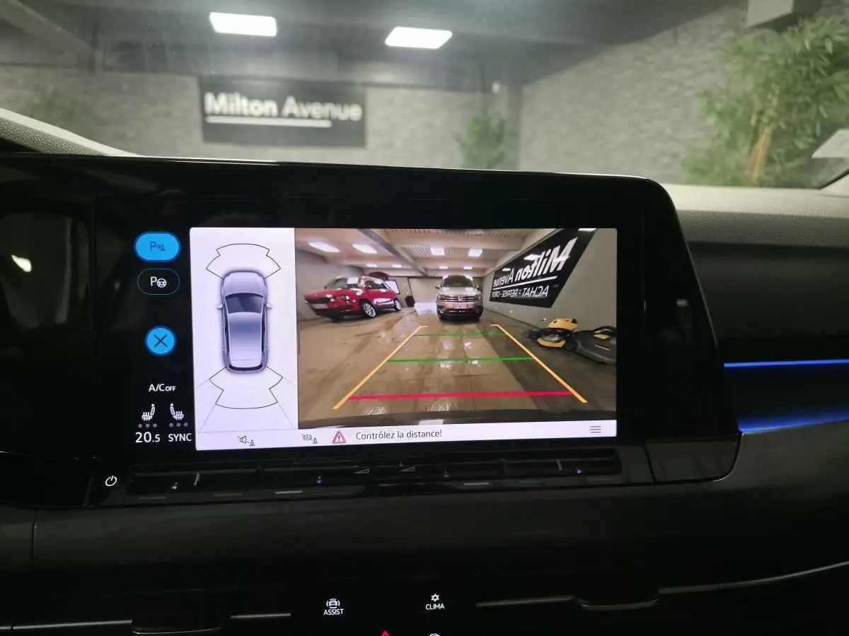 Vue arrière sur l'écran de la Volkswagen Golf 1.4 eHybrid gris montrant la caméra de recul en intérieur de garage.