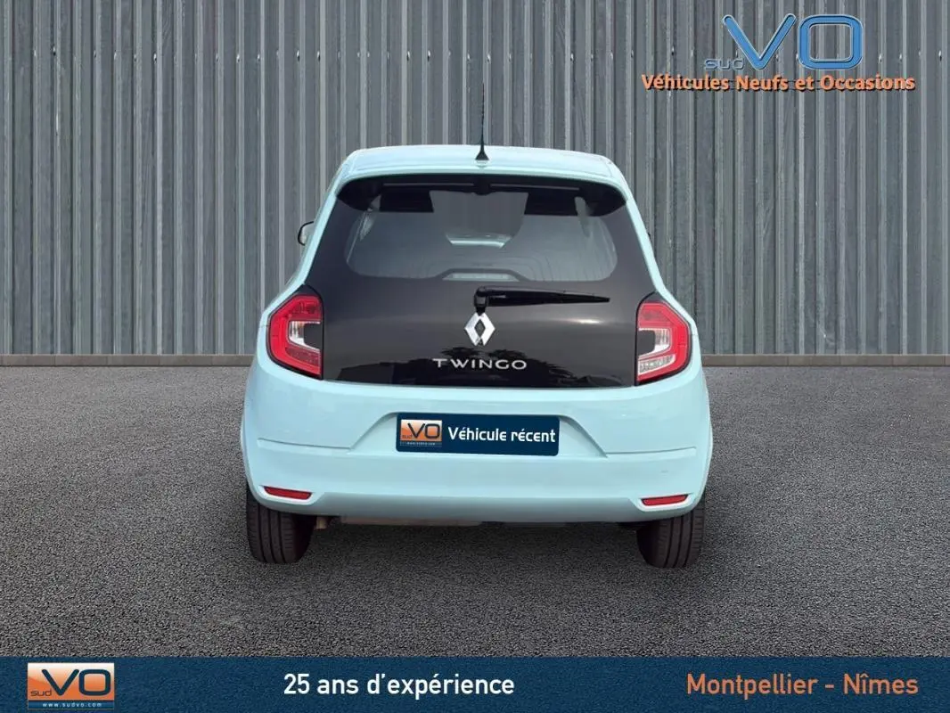Vue arrière d'une Renault Twingo III bleu clair avec lunette arrière noire et feux rouges distinctifs.