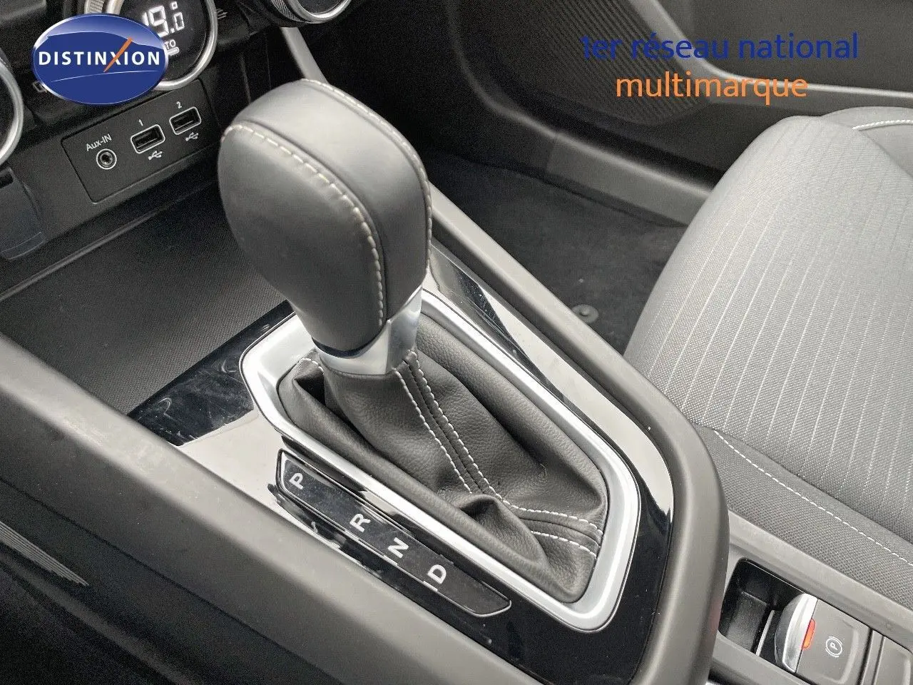 Le levier de vitesses automatique noir de la Renault Arkana 1.3 TCE 140 Evolution, avec coutures blanches, vue rapprochée intérieure.