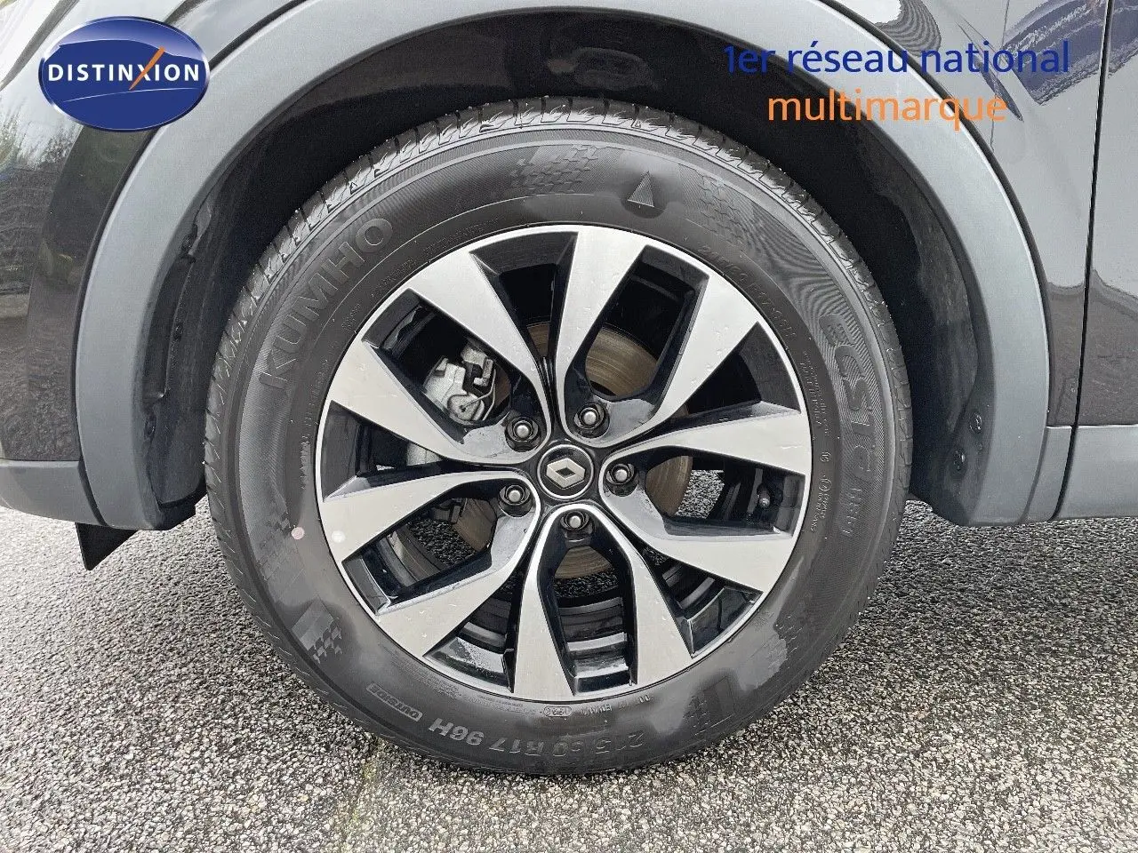 Gros plan sur la roue avant droite noire du Renault Arkana 1.3 TCE 140 Evolution avec jante alliage bicolore.