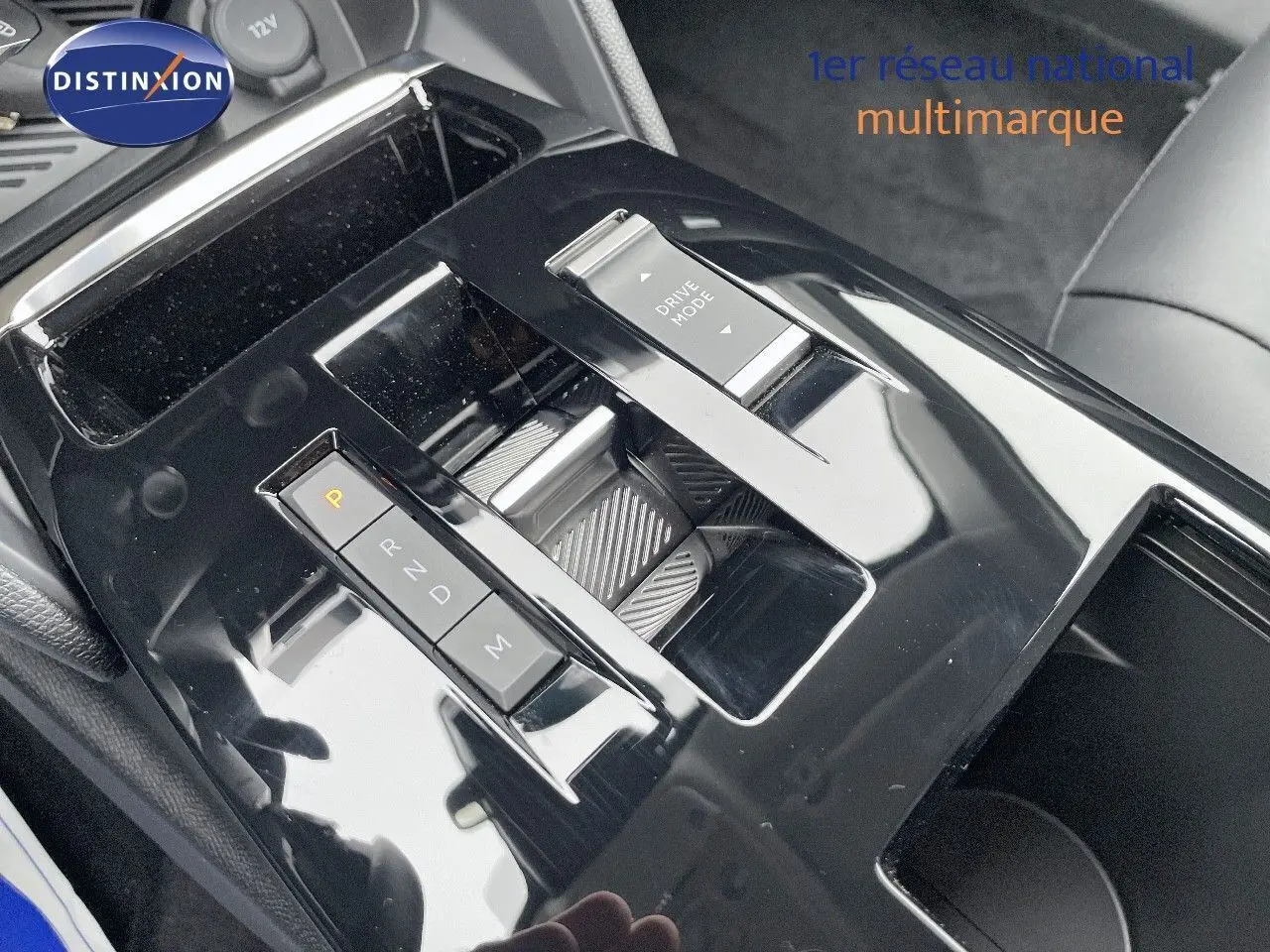 Gros plan sur la console centrale noire brillante de la Citroën C4 2024 avec commandes de boîte auto et mode de conduite.