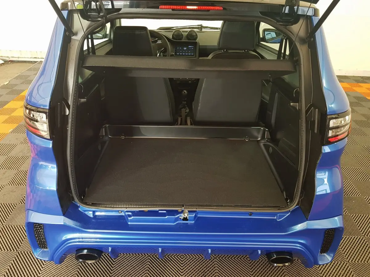Vue arrière ouverte de l'AIXAM AMBITION 0.5 CITY SPORT bleu 2026, montrant le coffre vide et l'intérieur des sièges avant.