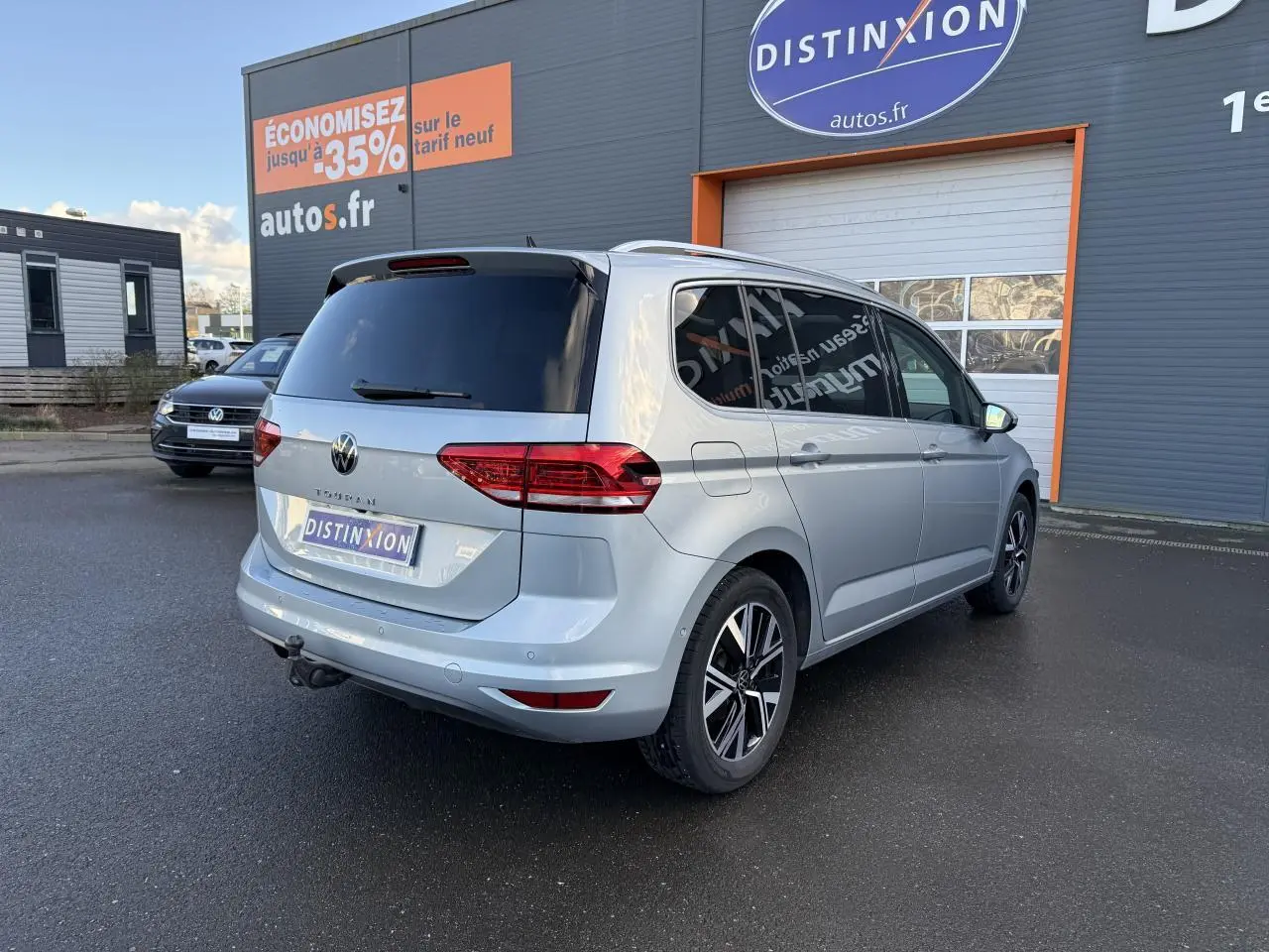 Volkswagen Touran argent Dolomite vu en 3/4 arrière droit avec jantes alliage et attelage escamotable