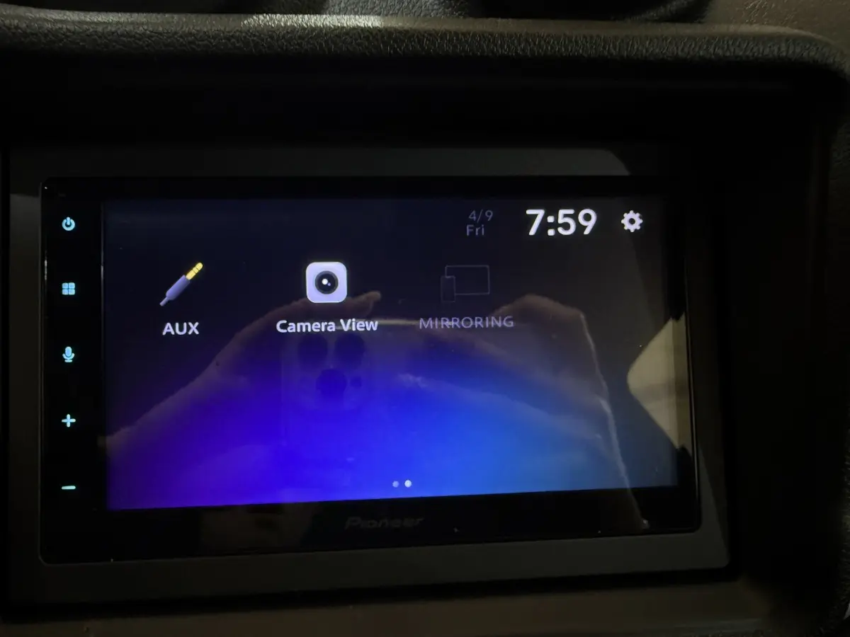 Écran tactile intérieur affichant l'interface caméra et options audio de l'AIXAM Ambition gris foncé, vue de face.