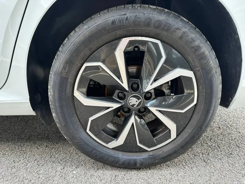 Gros plan sur la jante alu noire et argentée d'une Skoda Scala blanche, avec pneu Goodyear visible.