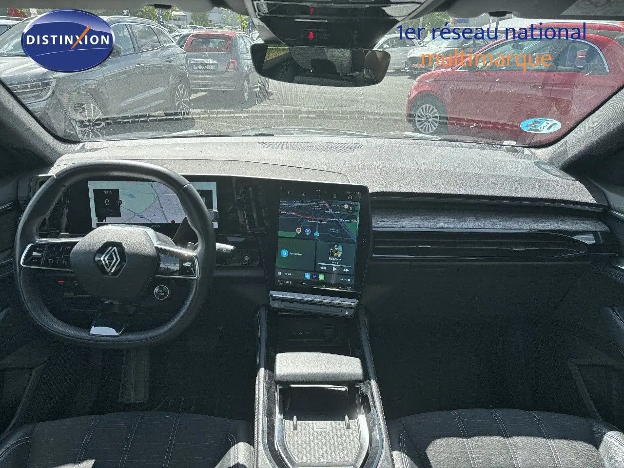 Intérieur du Renault Austral 2024 montrant le tableau de bord moderne avec écran tactile vertical et volant multifonction noir.