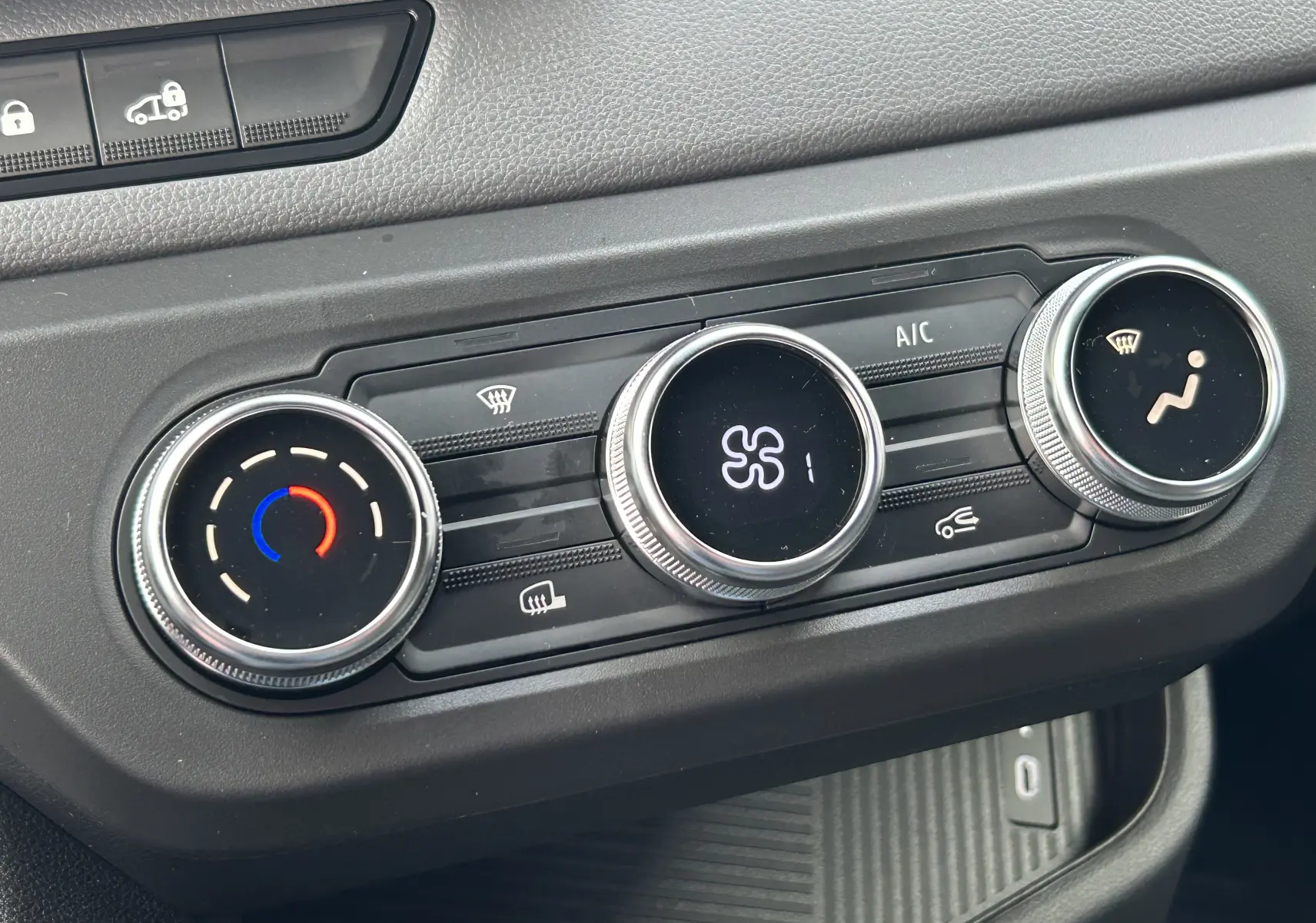 Gros plan sur les commandes de climatisation du Renault Master 2025, avec réglages circulaires et affichage digital.