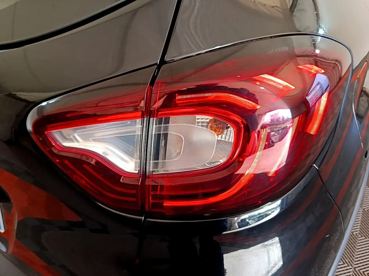 Gros plan sur le feu arrière droit rouge et blanc d’un Renault Captur Business TCe 90 noir de 2018.
