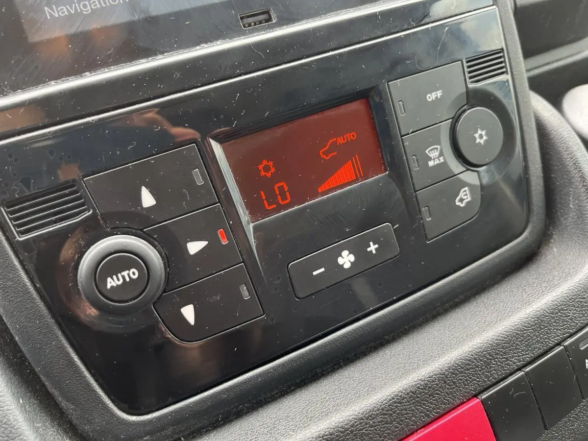 Détail du tableau de bord noir du Peugeot Boxer Fourgon 2023 montrant la climatisation automatique en mode « LO ».