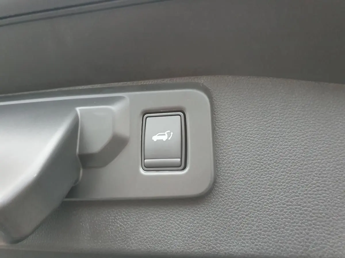 Bouton d'ouverture électrique du hayon sur panneau intérieur gris foncé du Renault Austral 2025.