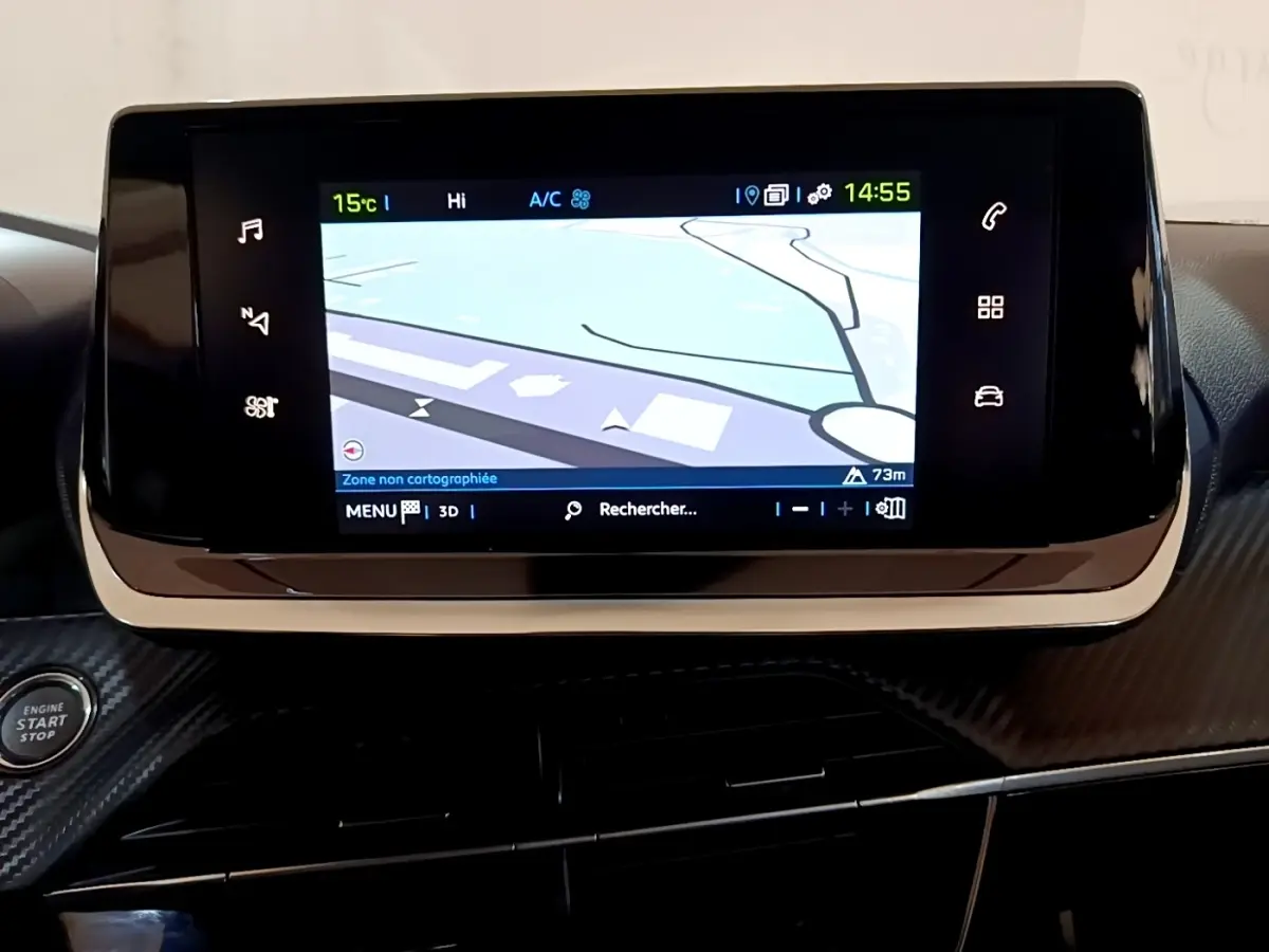 Écran tactile central avec navigation affichée dans l’habitacle noir de la Peugeot 208 électrique blanche, vue intérieure frontale.