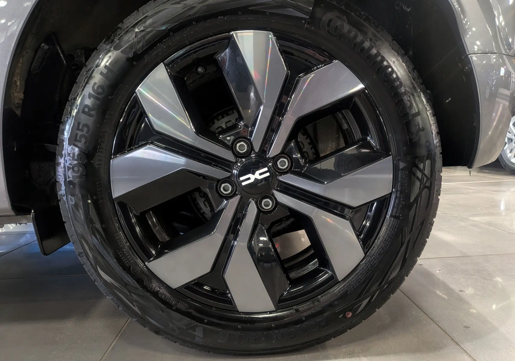 Gros plan sur la jante alliage noire et grise du côté gauche d'une Dacia Sandero TCe 90 CH Journey gris schiste 2025.