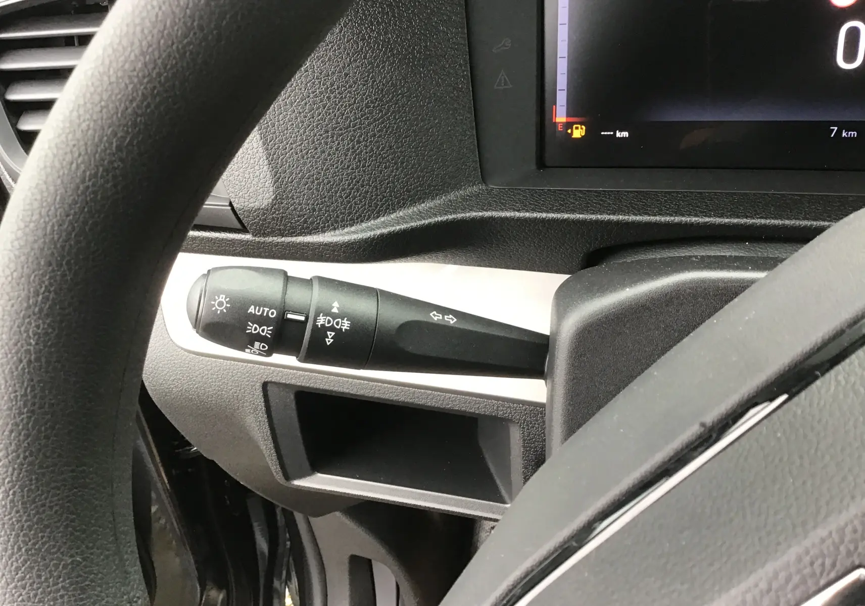 Gros plan sur la commande des phares et clignotants à gauche du volant dans l'habitacle du Fiat Scudo Combi.