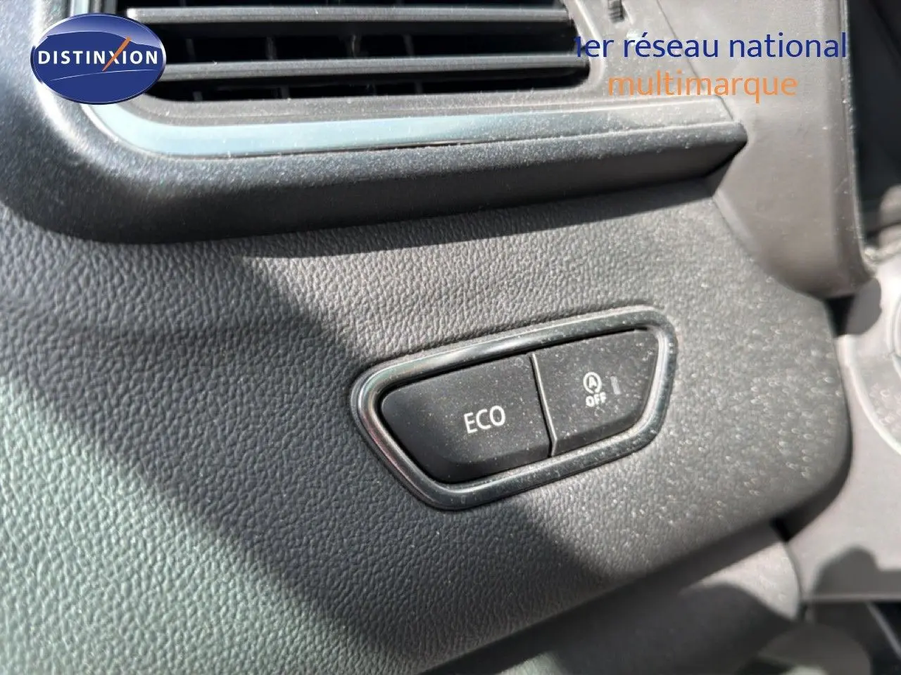Détail intérieur montrant les boutons ECO et arrêt du système start-stop sur tableau de bord noir du Renault Kadjar gris Highland.