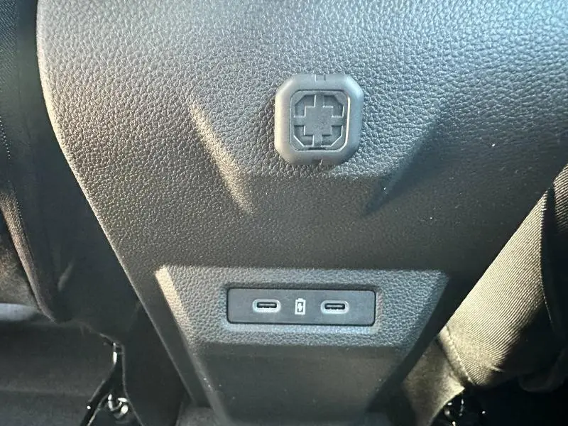 Prise USB double en gros plan sur la console arrière noire du Dacia Bigster blanc 2025.