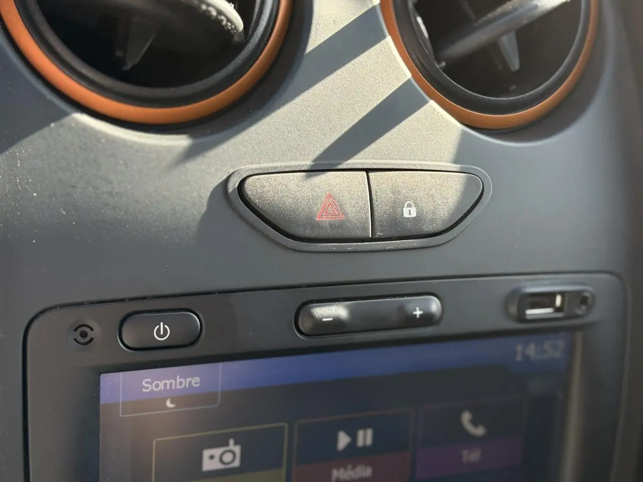 Détail du tableau de bord du Dacia Duster blanc Glacier 2017 montrant les commandes d'alerte et l'écran tactile GPS.