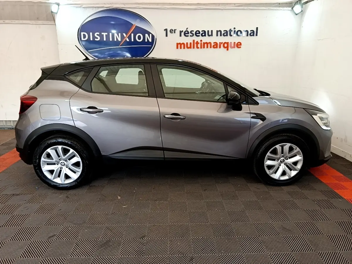 Vue latérale droite d’un Renault Captur Zen E-Tech hybride gris foncé 2022, avec jantes alliage et toit noir contrasté.