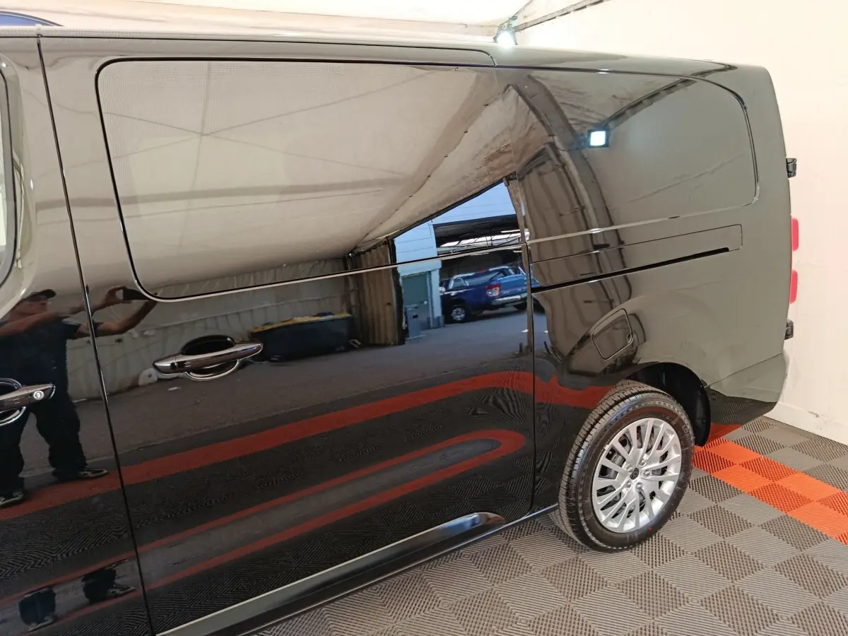Vue latérale droite du Peugeot Expert Fourgon XL noir, mettant en valeur la porte coulissante et la roue arrière.