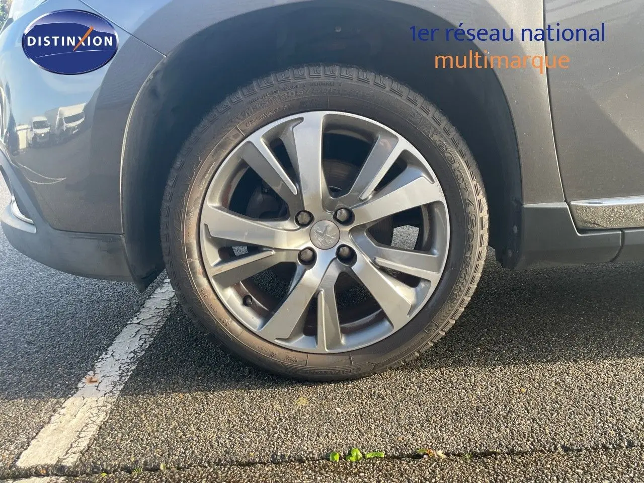 Gros plan sur la roue avant gauche gris platinium métal d'un Peugeot 2008 Crossway 2019, jante alliage biton.