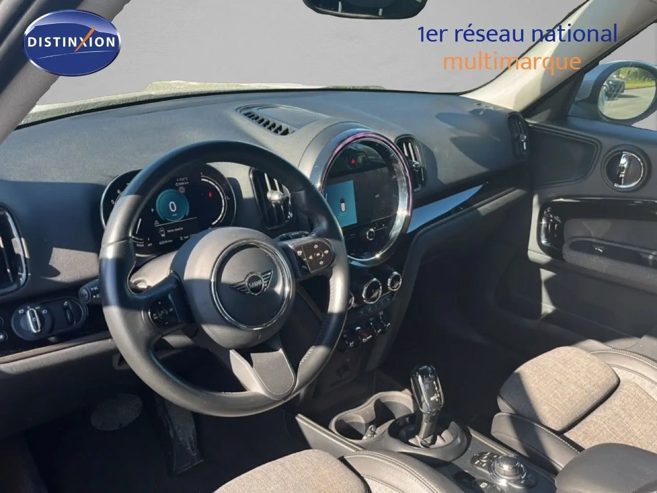Vue intérieure côté conducteur du tableau de bord et volant noir d'une MINI Countryman 2023, ambiance moderne et épurée.