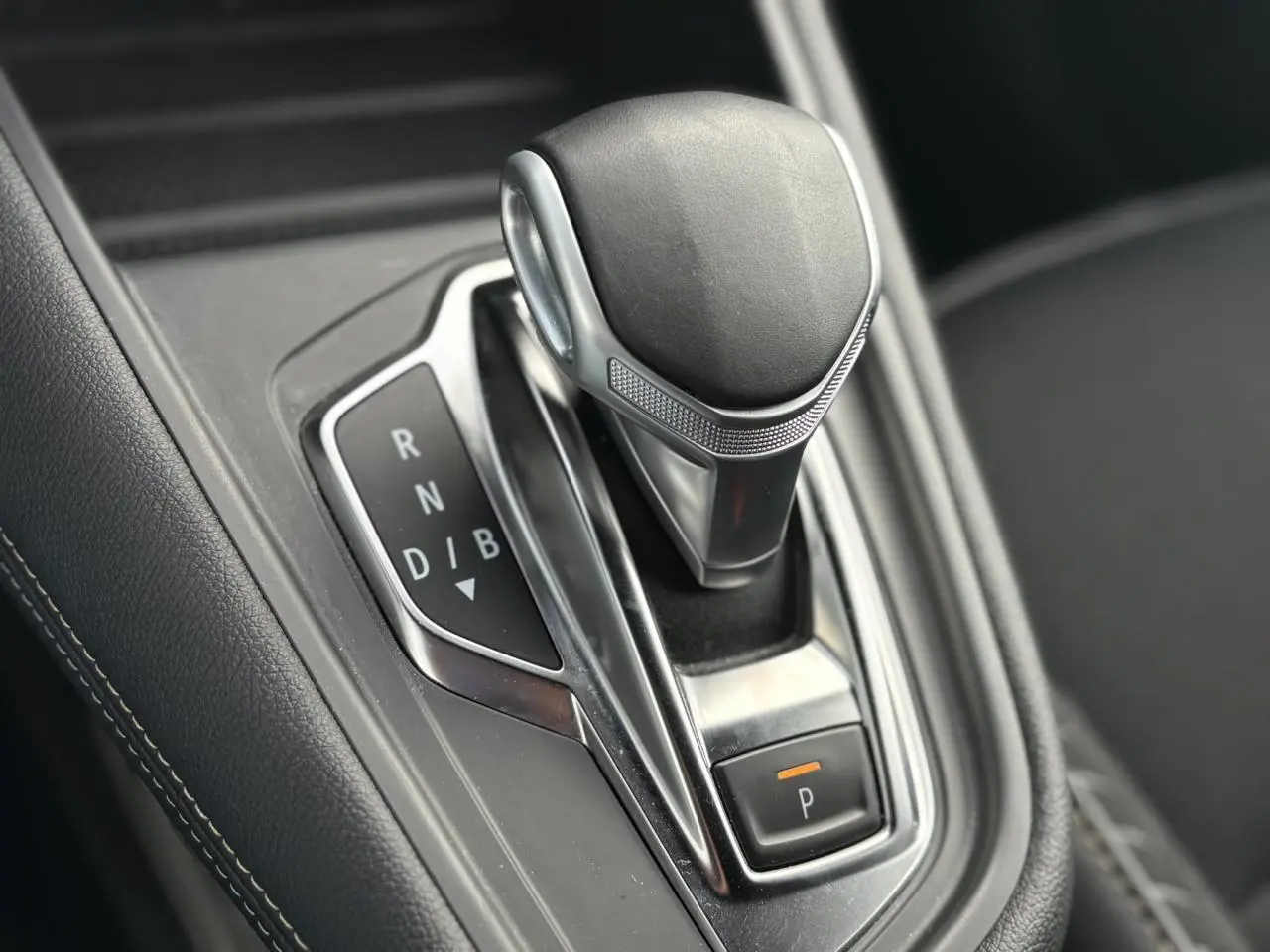 Le levier de vitesse automatique noir et chrome du Renault SYMBIOZ E-Tech Full Hybrid, vue rapprochée intérieure.