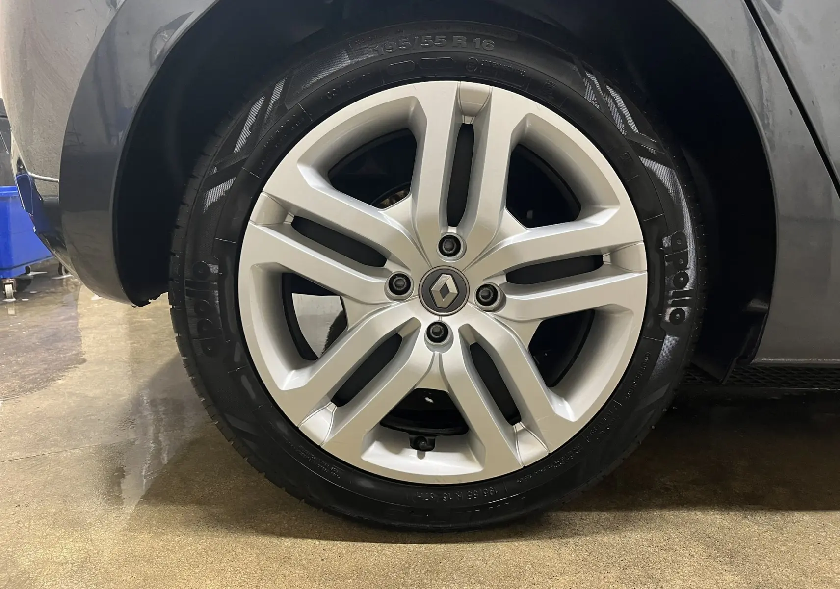 Gros plan sur la roue avant droite d'une Renault Clio V gris titanium, mettant en valeur la jante alliage et le pneu Apollo.