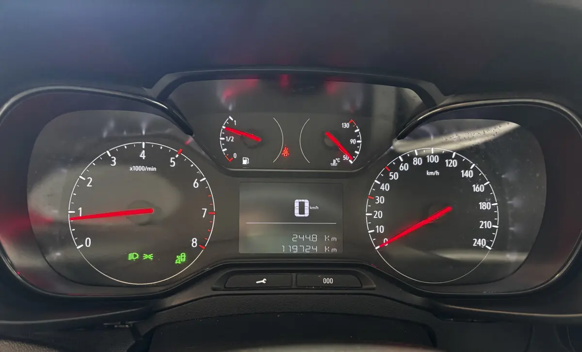 Tableau de bord de l'Opel Combo blanc 2021, affichage digital au centre avec compte-tours et vitesse analogiques.