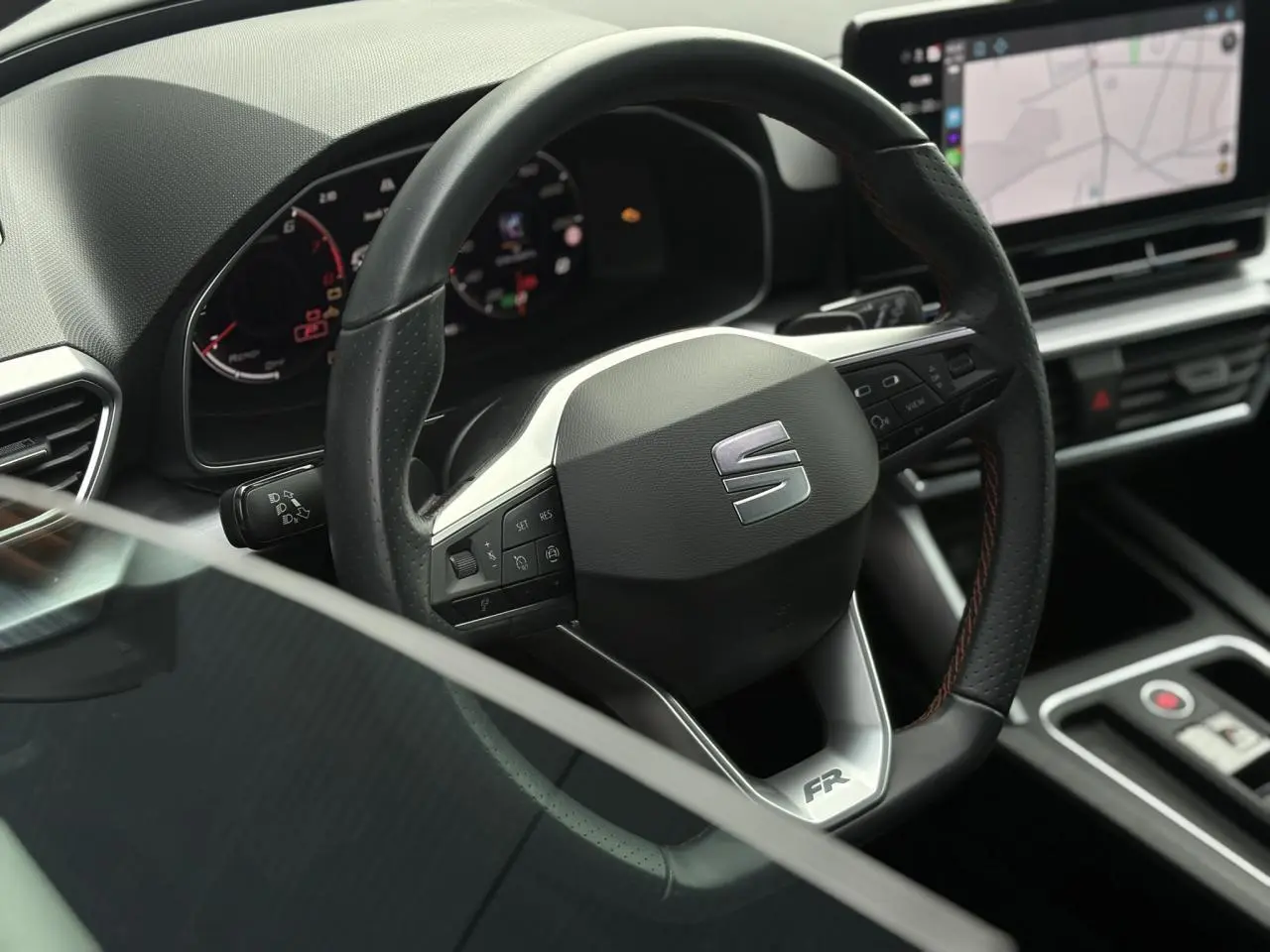 Volant cuir multifonction avec logo FR dans l'habitacle moderne du SEAT LEON 1.5 e-TSI 150 DSG7, vue rapprochée.