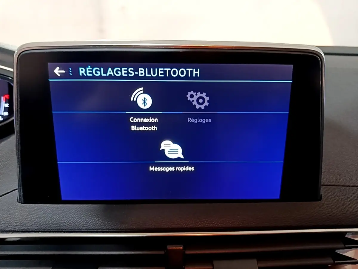 Écran tactile central affichant les réglages Bluetooth dans l'habitacle du Peugeot 5008 gris clair, vue de face.