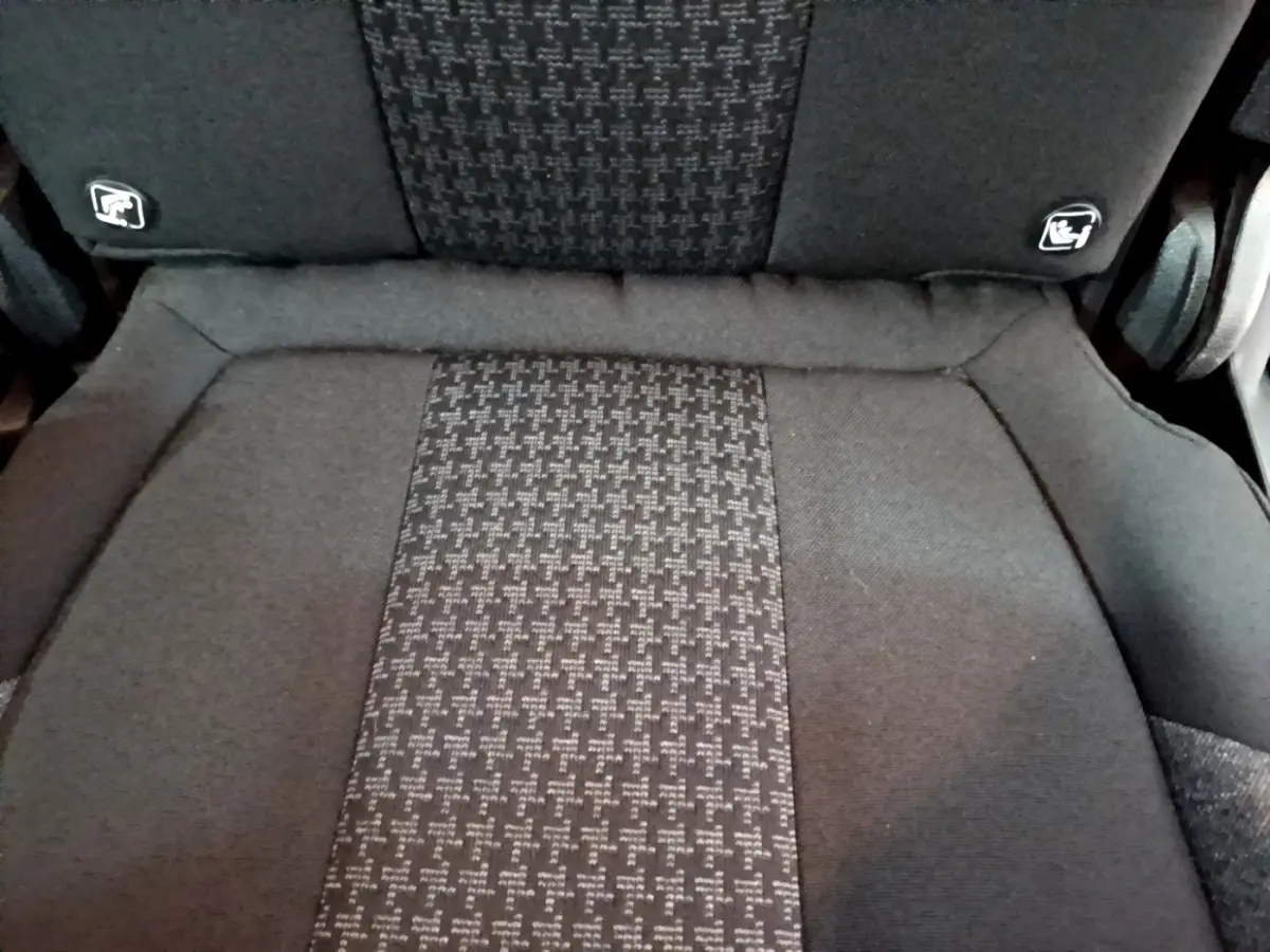 Gros plan sur le siège individuel arrière gris foncé du Peugeot 5008 avec logos Isofix visibles sur le dossier.