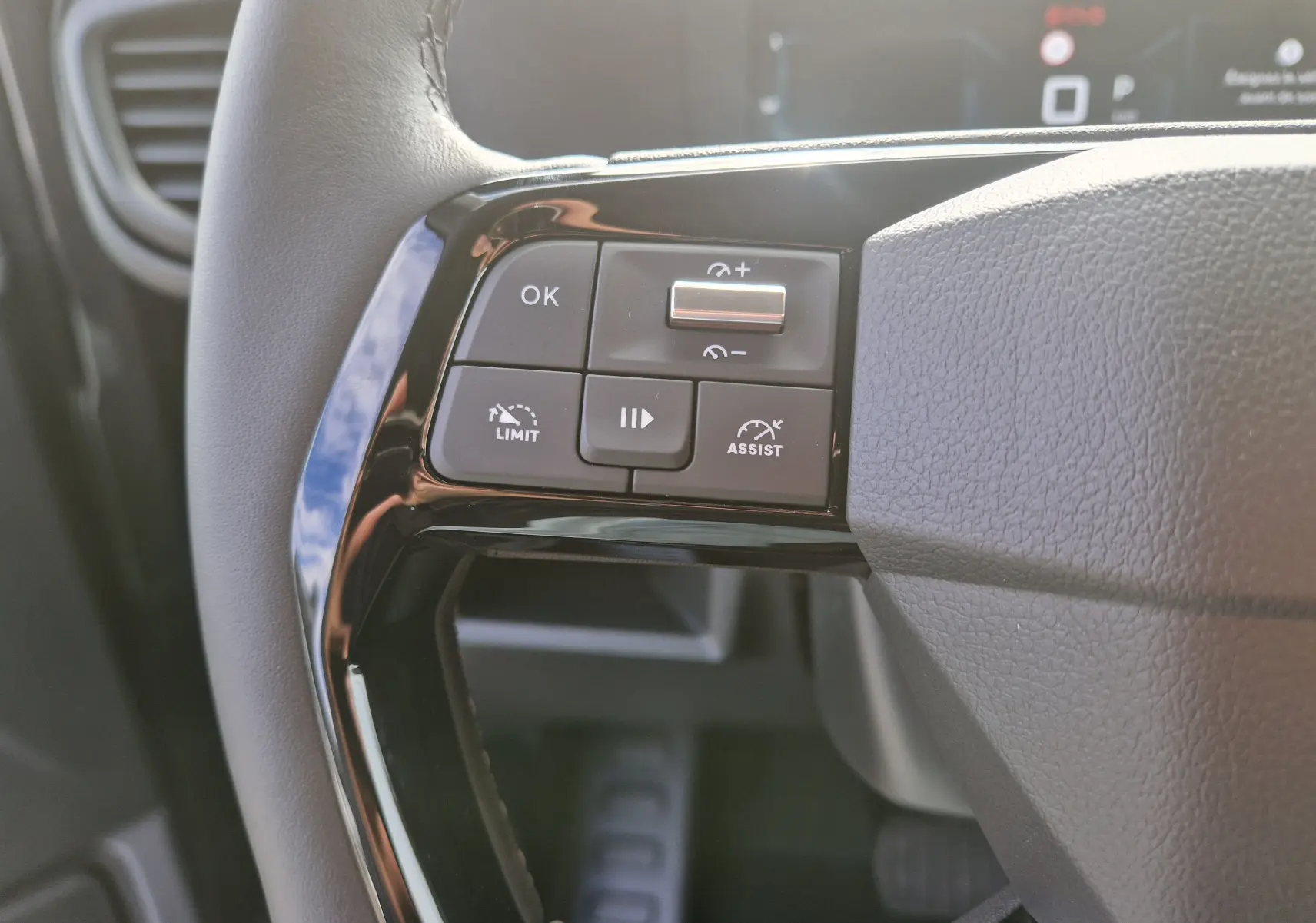 Gros plan sur les commandes de régulateur de vitesse au volant cuir du Citroën Jumpy Cabine Approfondie gris titane.